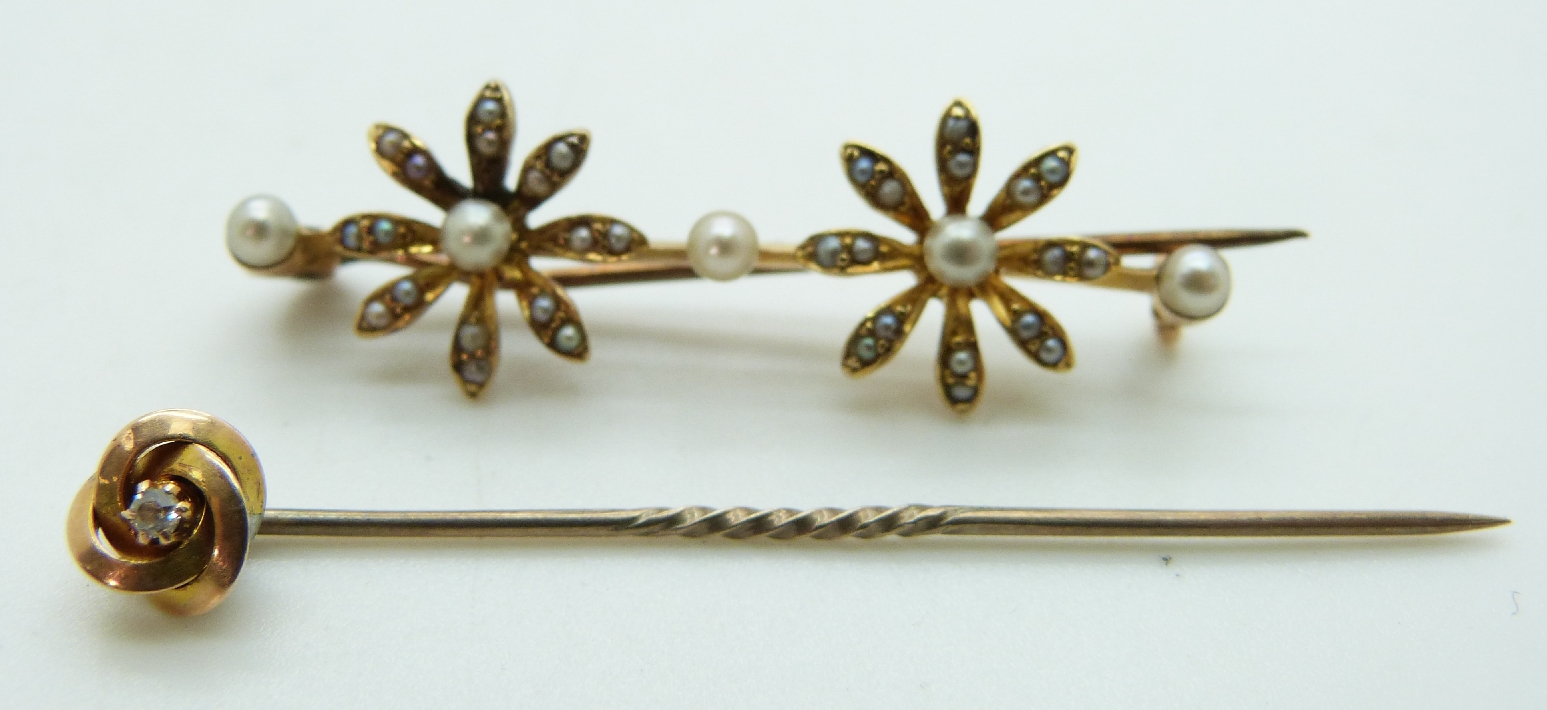 Edwardian brooch set with seed pearls in a floral design and a 15ct gold stick pin set with a