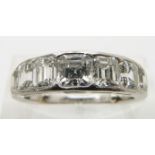 A 1930's Cartier platinum ring set with alternating asscher and emerald cut diamonds, the centre