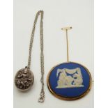 An Indian white metal locket and a Jasperware brooch possibly Wedgwood