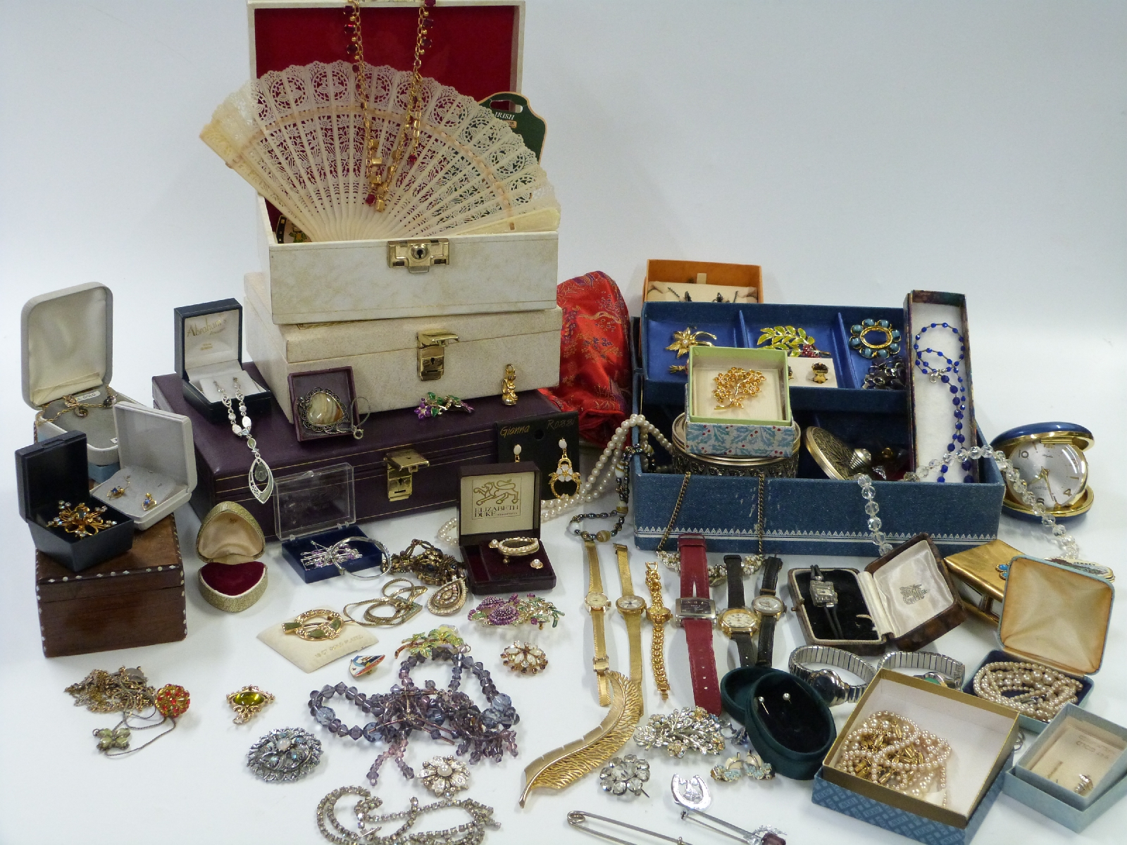 A collection of costume jewellery including large enamel brooches, marcasite, watch, necklaces,