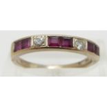 A 9ct gold ring set with square cut rubies and two round cut diamonds, size O