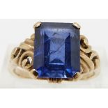 A 9ct gold ring set with an emerald cut sapphire, size O