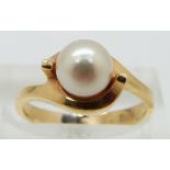 An 18ct gold ring set with a pearl, size K