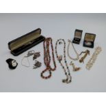 A collection of costume jewellery to include silver and marcasite watch, silver pendant, pearl