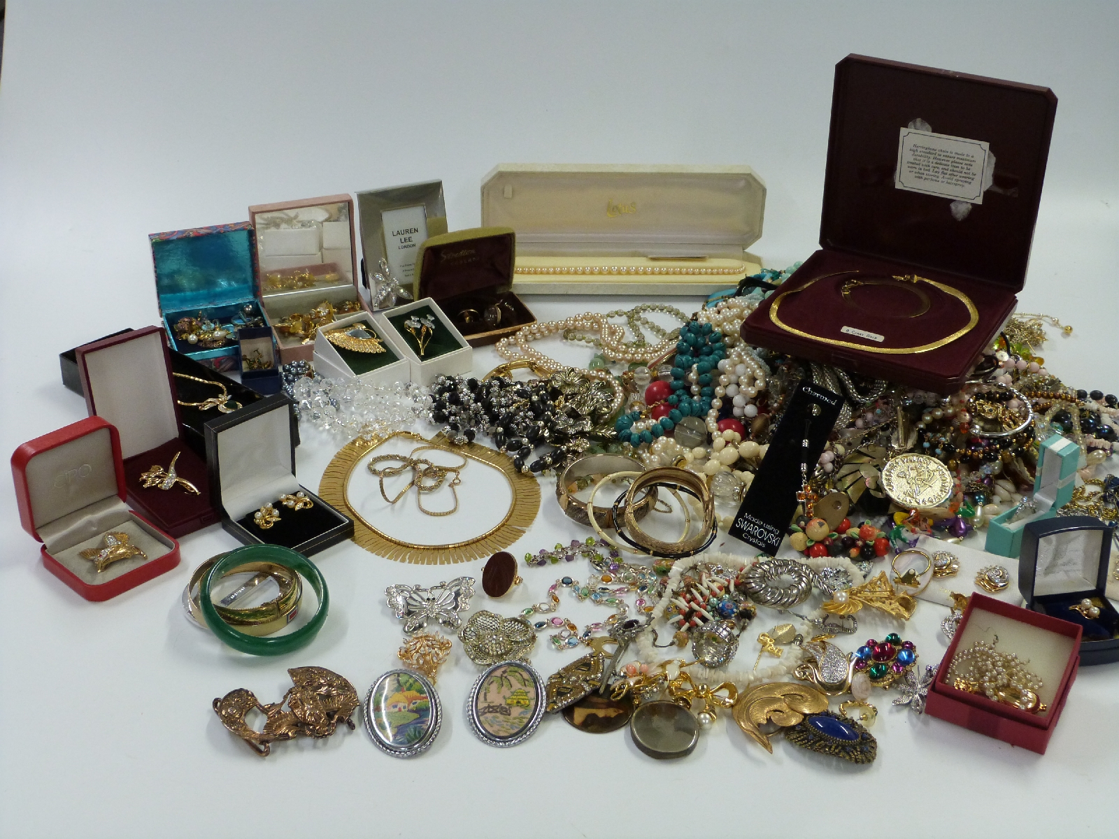 A large collection of costume jewellery including pearl bracelet, silver ring, brooches,