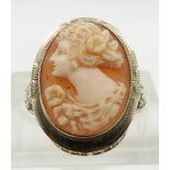 A 14k white gold ring set with a shell cameo and with pierced shoulders, size L
