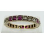 A 9ct gold eternity ring set with square cut rubies and cubic zirconia, size O