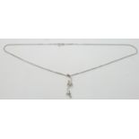 A platinum pendant set with a diamond in a floral design, 2.4g and a 9ct white gold chain, 2.5g