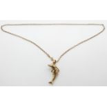 A 9ct gold articulated pendant in the form of a dolphin set with paste on 9ct gold chain, 7.83g