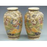 A pair of Japanese Satsuma vases decorated with figures and dragons, height 30cm