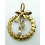 A 14ct gold pendant set with diamonds and a pearls in a wreath and bow design, 2cm