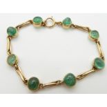 An 18ct gold bracelet set with emerald cabochons, 19.4g