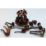 A collection of pipes and pipe stand for seven named days, with pipes including sterling silver