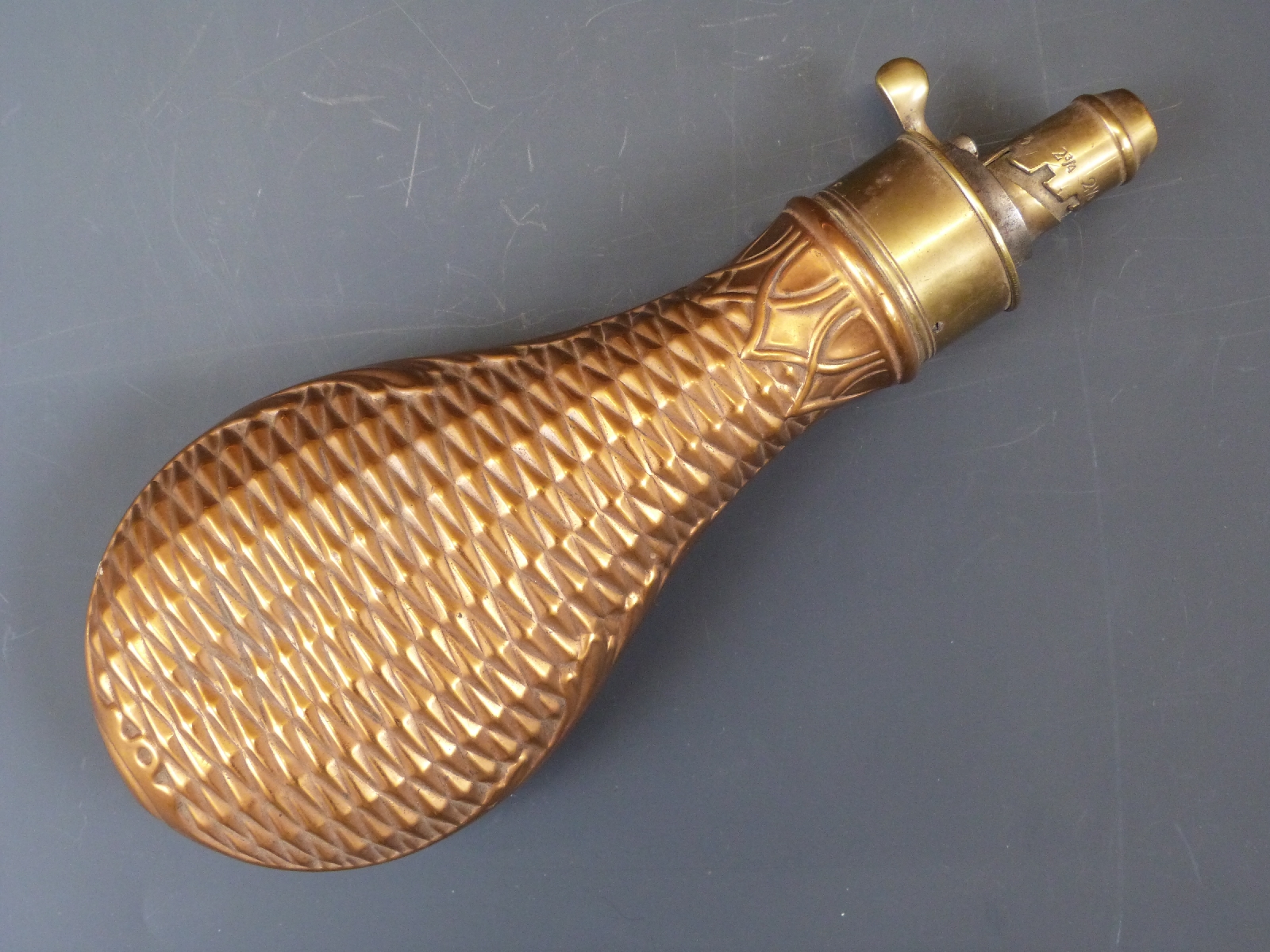 G & J W Hawksley copper and brass powder flask with embossed geometric and acanthus leaf decoration,