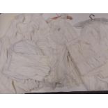 A quantity of 19th / 20thC textiles including children's hand embroidered petticoats, aprons,