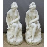 Two garden statues of semi nude seated ladies, height 60cm