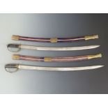 Two small swords in scabbards made in India. Blade length 77cm.