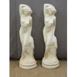 A pair of garden statues of semi nude ladies with arms above their heads, height 85cm