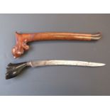 A Polynesian / Kris style dagger with sheath. Blade length 22cm.