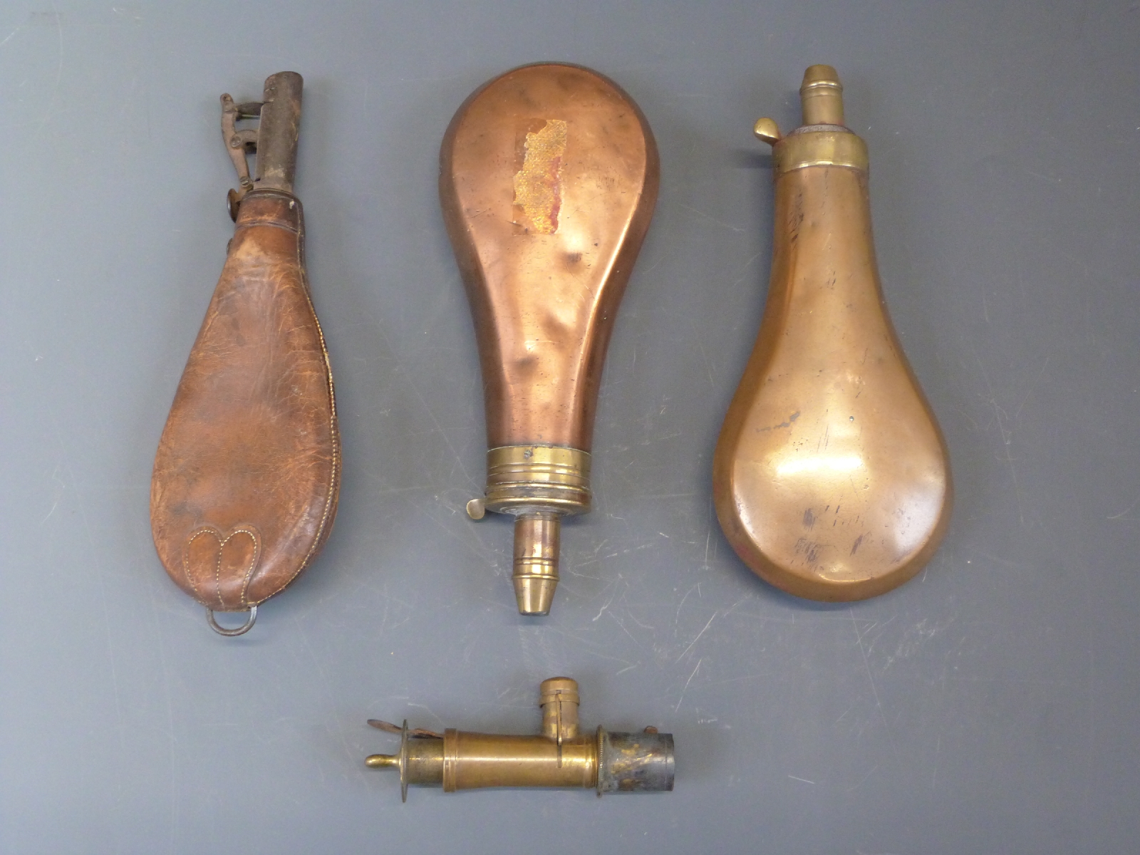 Two copper and brass powder flasks one Dixon & Sons (19.5cm long) the other Sykes (20cm long)