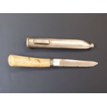 A late 19th/20thC ivory handled hunting or skinning knife in metal scabbard, the blade impressed C