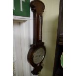 An oak aneroid banjo barometer.