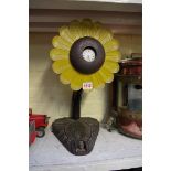 A novelty carved and painted wood sunflower watch stand, 44.5cm high; with a silver pocket watch.