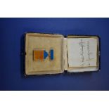 An antique Arabic Cornelian plaque engraved text, with blue enamel and white metal bar brooch mount,