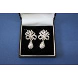 A pair of 18ct white gold diamond bow and teardrop earrings, approx 3.