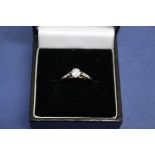 An unmarked diamond solitaire ring, having diamond shoulders, approximately 0.3ct.