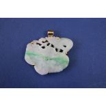 A carved and pierced jade lotus flower and stork, having unmarked yellow metal pendant mount.