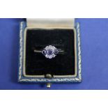 An unmarked Edwardian sapphire and diamond floral ring.