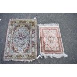 A Persian silk prayer rug having floral decoration; together with a smaller example,