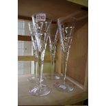 A set of four champagne flutes, 27cm high.