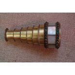 A mother of pearl and gilt brass small six drawer pocket opera monocular, 9.5cm extended.