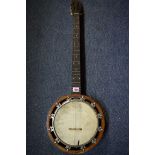 An old walnut six string banjo, in case.