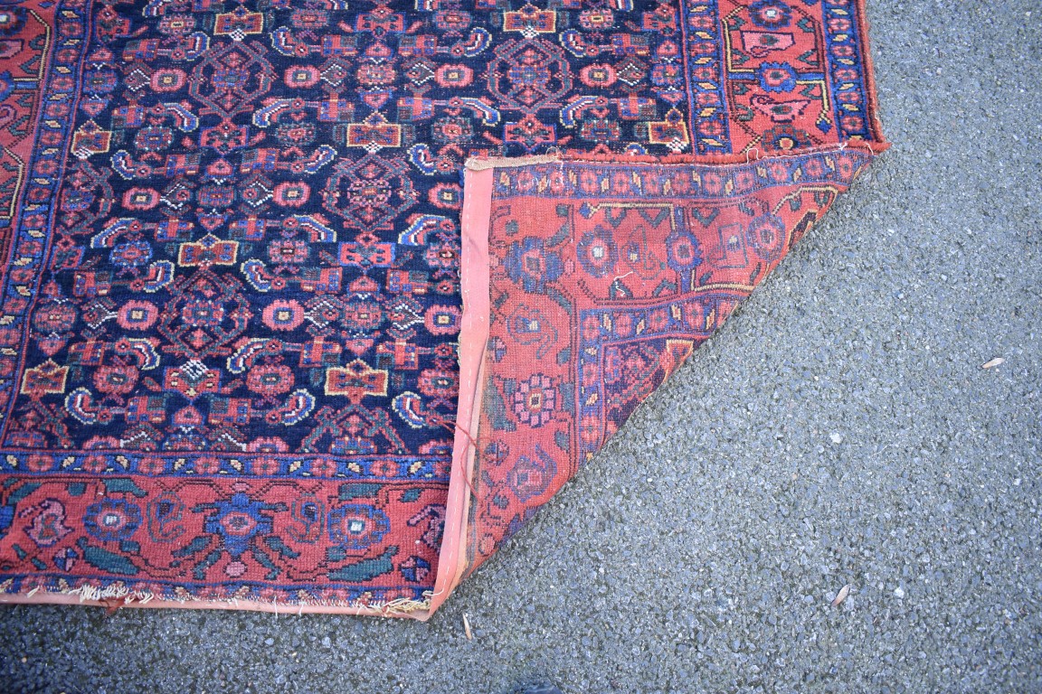 An Eastern wool rug having geometric design on red and brown ground; - Image 8 of 8