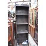 An early 20th century oak narrow bookcase, by Liberty & Co, labelled, 33.5cm wide.