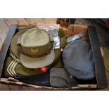 A quantity of military caps and uniforms.