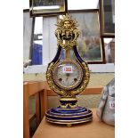 A reproduction Louis XVI style lyre clock, 38cm high.