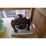 An oriental bronze three legged toad inkwell, on marble base, 16cm wide.