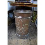 A large hammered copper twin handled umbrella stand, decorated with a fleur de lys motif, 58cm high.
