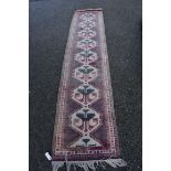 An Eastern style runner, having floral and geometric design, 284 x 64cm.