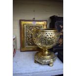 A brass lamp base; together with another mahogany mounted pierced brass plaque.