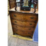 A reproduction walnut serpentine fronted four drawer chest, 61cm wide.