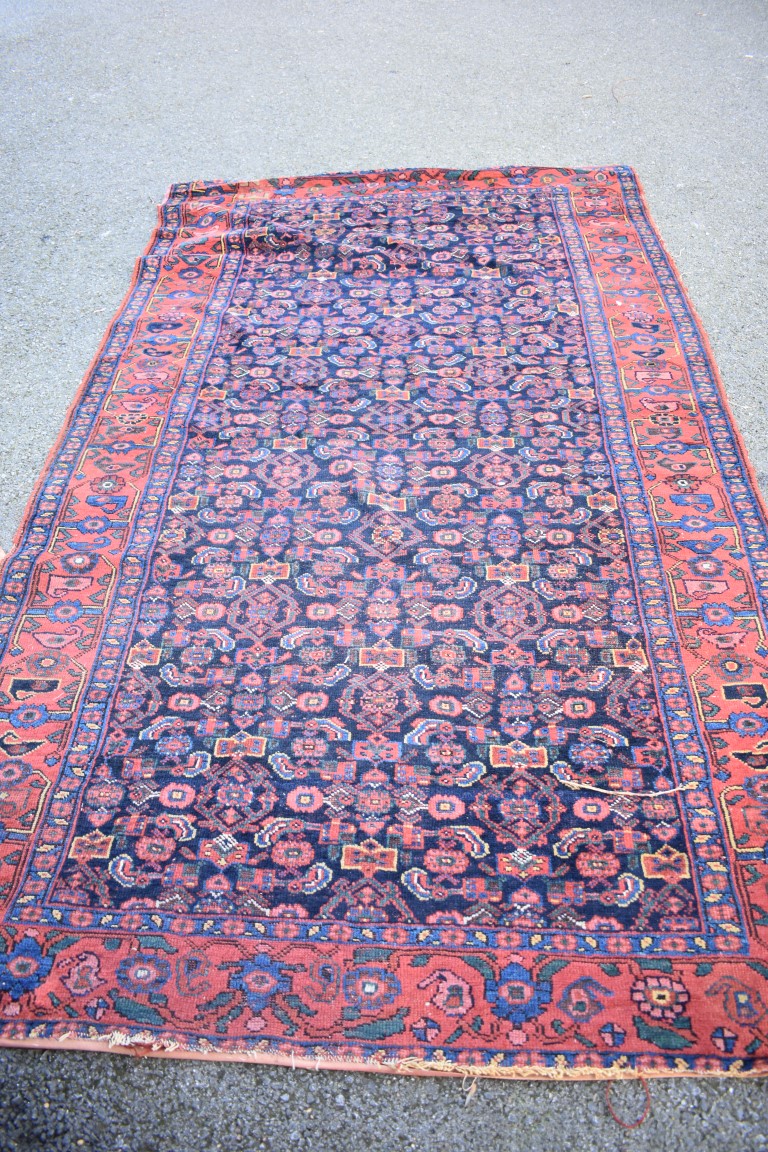 An Eastern wool rug having geometric design on red and brown ground; - Image 5 of 8