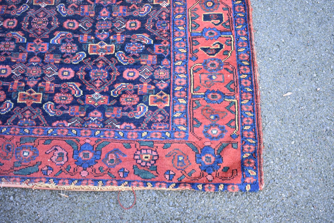 An Eastern wool rug having geometric design on red and brown ground; - Image 7 of 8