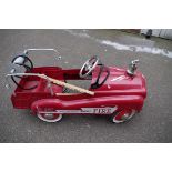 A child's fire engine pedal car.