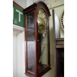 A reproduction mahogany musical wall clock, by Comitti, striking on 8 straight gongs, 77cm high.