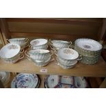 A set of twelve Royal Doulton porcelain 'Camrose' pattern breakfast cups and saucers, (chips).